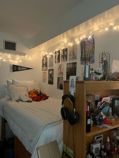 a bed room with a neatly made bed and headphones