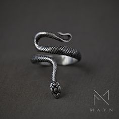 A gothic snake ring is a captivating and darkly elegant piece of jewelry that draws inspiration from the mystique of serpents. Crafted with meticulous attention to detail, it features a serpent motif that embodies a sense of mystery and allure. Whether worn as a statement piece or a subtle nod to mysticism, a snake ring adds an intriguing and timeless element to your jewelry collection. ◾️ SPECIFICATIONS ◾️ Material: 316 Stainless Steel Type: Handmade Ring Durable: Anti-scratch / Waterproof / No Elegant Snake-shaped Metal Rings, Elegant Black Snake-shaped Jewelry, Adjustable Gothic Snake Ring As Gift, Adjustable Gothic Snake Ring For Gift, Elegant Snake Shaped Metal Rings, Elegant Metal Ring In Snake Shape, Black Metal Snake-shaped Jewelry, Unique Black Snake-shaped Jewelry, Silver Snake-shaped Ring For Formal Occasions