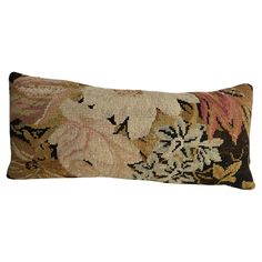 a decorative pillow with floral designs on the front and back, sitting on a white background