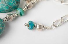 We've heard the bells and we know you will love this necklace! With two strands of speckled turquoise, turquoise glass spacers, and silver urn beads, this necklace is sure to make a statement. The silver adjustable length makes it perfect for any occasion, you can customize it to fit your style. With its empowering tone of voice, Heard the Bells is perfect for anyone who wants to make a statement. Artisan Silver Turquoise Necklace With Spacer Beads, Silver Turquoise Necklace With Faceted Round Beads, Adjustable Turquoise Necklace With Polished Beads, Adjustable Silver Turquoise Necklace With Polished Beads, Adjustable Silver Turquoise Necklace With Silver Beads, Silver Turquoise Necklace With Spacer Beads For Gift, Bohemian Silver Turquoise Necklace With Spacer Beads, Adjustable Turquoise Necklace With Silver Beads, Tone Of Voice