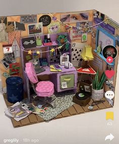 a doll house with furniture and decorations on the floor, including a desk and chair