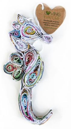 a paper sculpture made to look like a lizard with colorful swirls on it's tail