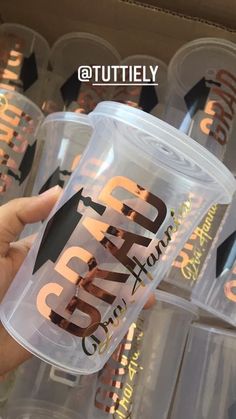 someone holding up a plastic cup with the word grind on it in front of other cups