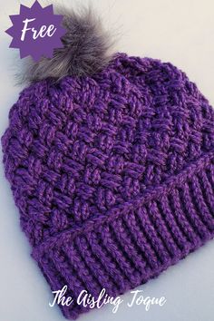 a crocheted beanie with a pom - pom on the top