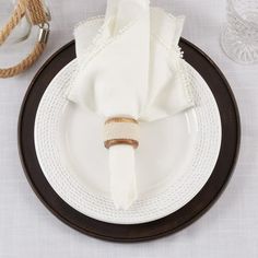 a white plate topped with a napkin on top of a table