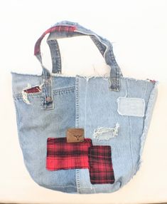 "These designer tote bags are as soft and comfortable as your best pair of boyfriend jeans paired with a big slouchy soft flannel. Constructed from worn and weathered sturdy jeans. They have been reinforced in all the right places. Perfectly distressed with pockets, holes, patches and leather labels. It's perfect for holding everything you need. With pockets inside and out to help keep you organized. Fresh cotton canvas lines the inside of the bag. With pockets and patches to make sure the insid Casual Canvas Bags With Upcycled Details, Trendy Upcycled Tote Bag, Casual Upcycled Tote Bag, Casual Upcycled Shopping Bags, Casual Distressed Bags For Daily Use, Casual Everyday Upcycled Bags, Casual Upcycled Bags From Recycled Denim, Casual Upcycled Bags Made Of Recycled Denim, Casual Upcycled Bags Made From Recycled Denim