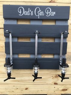 the dad's gin bar is made from pallets and has three bottles attached to it