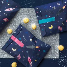 three bags with outer space designs on them, one is filled with macaroni and cheese