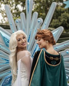 two women dressed in costumes standing next to each other