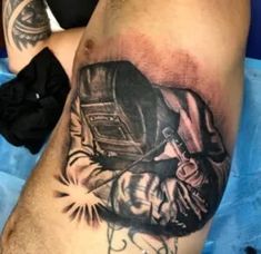 a man's leg with a tattoo on it that has an image of a person holding