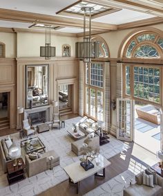 a large living room with lots of windows and furniture