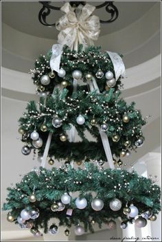 a christmas tree decorated with ornaments and bows