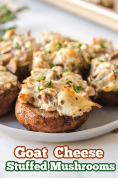 a white plate topped with stuffed mushrooms covered in cheese