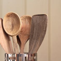 several wooden spoons in a metal holder