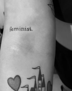 a black and white photo of a woman's arm with the words feminist on it