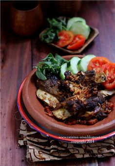 a plate full of food sitting on top of a wooden table