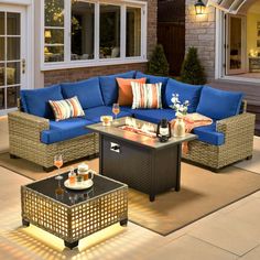 an outdoor living room with blue couches and coffee table