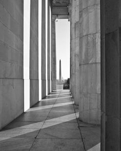 black and white photograph of the lincoln memorial in washington d c, with columns on either side