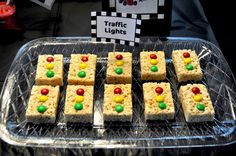 there are many squares of rice krispy treats on the tray with candy candies