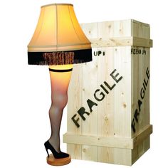 a lamp that is next to a wooden crate with the word fragile on it and a light shade