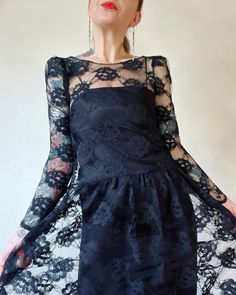 "Lacey layers. Beautiful Vintage 1970's/1980's jet back lace babydoll style dress with gathered puff shoulder caps, scooped back and wiggle slip underlay by Brannan Street, San Francisco, likely sold at Sakowitz dept store in Texas. Dreamy and dark, and I'm in love.  Marked a vintage 5/6  Fits XS/S (I'm about a M), but please use measurements as fit guide. Lace dress: 14.5\" shoulder  17.5\" bust (on the half)  17.25\" waist (on the half)  23.75\" sleeve  41\" length  Unlined  Slip on style  Sheer tulle/lace  Scooped back  Gathered shoulder caps  Drop waist with gathering  Scalloped edges throughout  Slip: Up to 17.5\" bust (on the half)  17.5\" waist (on the half)  19\" hip (on the half)  39.5\" length  Slip on style  Unlined  Partial elastic back  Feels like acetate  Excellent vintage co Babydoll Style Dress, Babydoll Style, Lace Babydoll, Shearling Coat, Tulle Lace, Drop Waist, Dress Clothes For Women, Style Dress, Vintage Shops