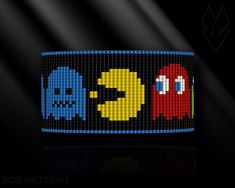 an image of a bracelet with pacman and ghostbuses on it's side