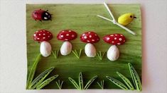 a group of mushrooms sitting on top of a green piece of paper next to a yellow bird