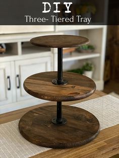 three tiered tray sitting on top of a wooden table