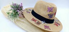 Grab this cool and stylish straw hat, hand-painted with adorable butterflies on the rim and top. It's light, flexible, and super comfy, perfect for any occasion -- beach days, brunch, or just hanging out outdoors. Head size: 58 Each hat is carefully hand-painted with love and great attention to details, making every piece truly unique. The hat can be customized  to match your creative vision. Handmade Whimsical Sun Hat For Summer, Whimsical Handmade Straw Hat For Summer, Whimsical Summer Beach Hats, Whimsical Adjustable Sun Hat For Summer, Whimsical Straw Hat For Summer Beach, Whimsical Straw Hat For Beach In Summer, Whimsical Adjustable Straw Hat For Summer, Spring Beach Sun Hat Hand Painted, Whimsical Straw Hat For Spring Vacation