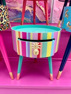 colorful painted furniture with pineapples on top and other items in the back ground