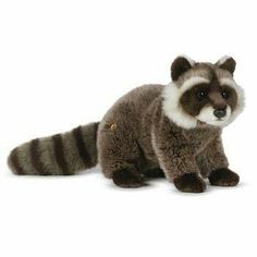 a raccoon stuffed animal sitting on top of a white surface