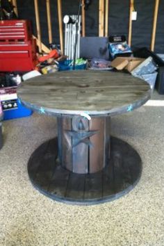 a round table sitting on top of a wooden floor next to other boxes and tools