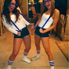 two women in cheerleader outfits posing for the camera