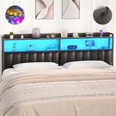 there is a bed with two blue lights on the headboard and an illuminated shelf above it