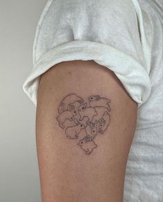 a woman's arm with a tattoo on it that has animals in the shape of a heart