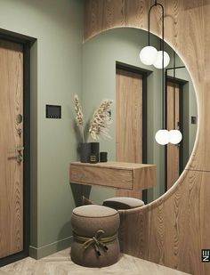 a mirror sitting on the wall above a dressing table with stools next to it