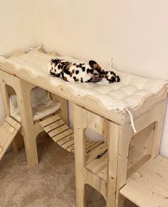 a dog laying on top of a wooden bed