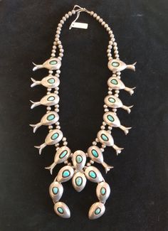 A pristine condition Navajo squash blossom Native American necklace, old pawn, circa 1950's The necklace measures 25 inches in length with a 3 1/2 x 3 1/2 inch Naja. This necklace weighs in at an impressive 9.4 ounces. The turquoise is the Kingman variety. This necklace, as is the normal policy here, has not been polished or refinished. Native American Necklace, Battle Creek, Native American Turquoise, Squash Blossom Necklace, Native Jewelry, Squash Blossom, Gold Cross, Vintage Sterling Silver, Gold Pendant