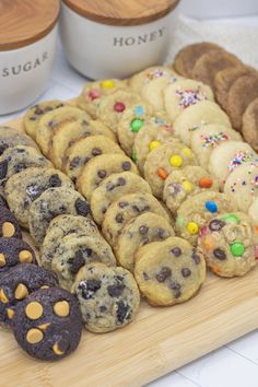 an assortment of cookies and muffins on a cutting board