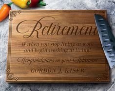 a wooden cutting board with the words retirement on it next to vegetables and a knife