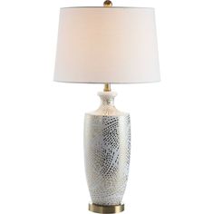 a table lamp with a white shade on the top and gold trim around the base