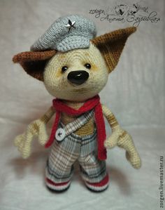 a small stuffed animal wearing a hat and scarf