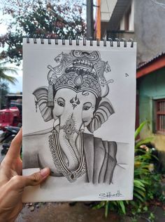 a drawing of an elephant with a crown on it's head is held up in front of a building