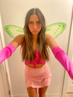 a woman with pink gloves and a butterfly costume