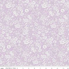 a purple and white flowered background with an area for the ruler to be used