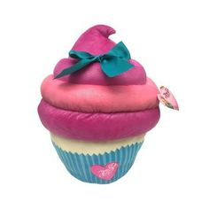 a pink and blue cupcake with a bow on it's top is sitting in front of a white background