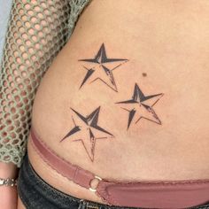 three stars on the side of a woman's stomach