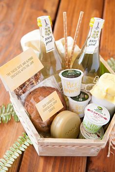 a basket filled with different types of food and drinks on top of a wooden table