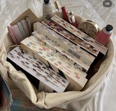 a basket filled with lots of different items on top of a bed