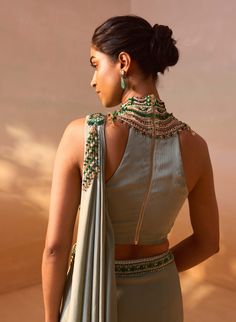 Sage green satin pre-draped sari paired with a jeweled high-neck embroidered blouse, creating a stunning and elegant ensemble. Gorgeous Lehengas, Unique Saree, Halter Neck Blouses, Net Embroidery, Draped Saree, Pista Green, Green Sleeveless Blouse, Embroidery Beads, Lehenga Wedding